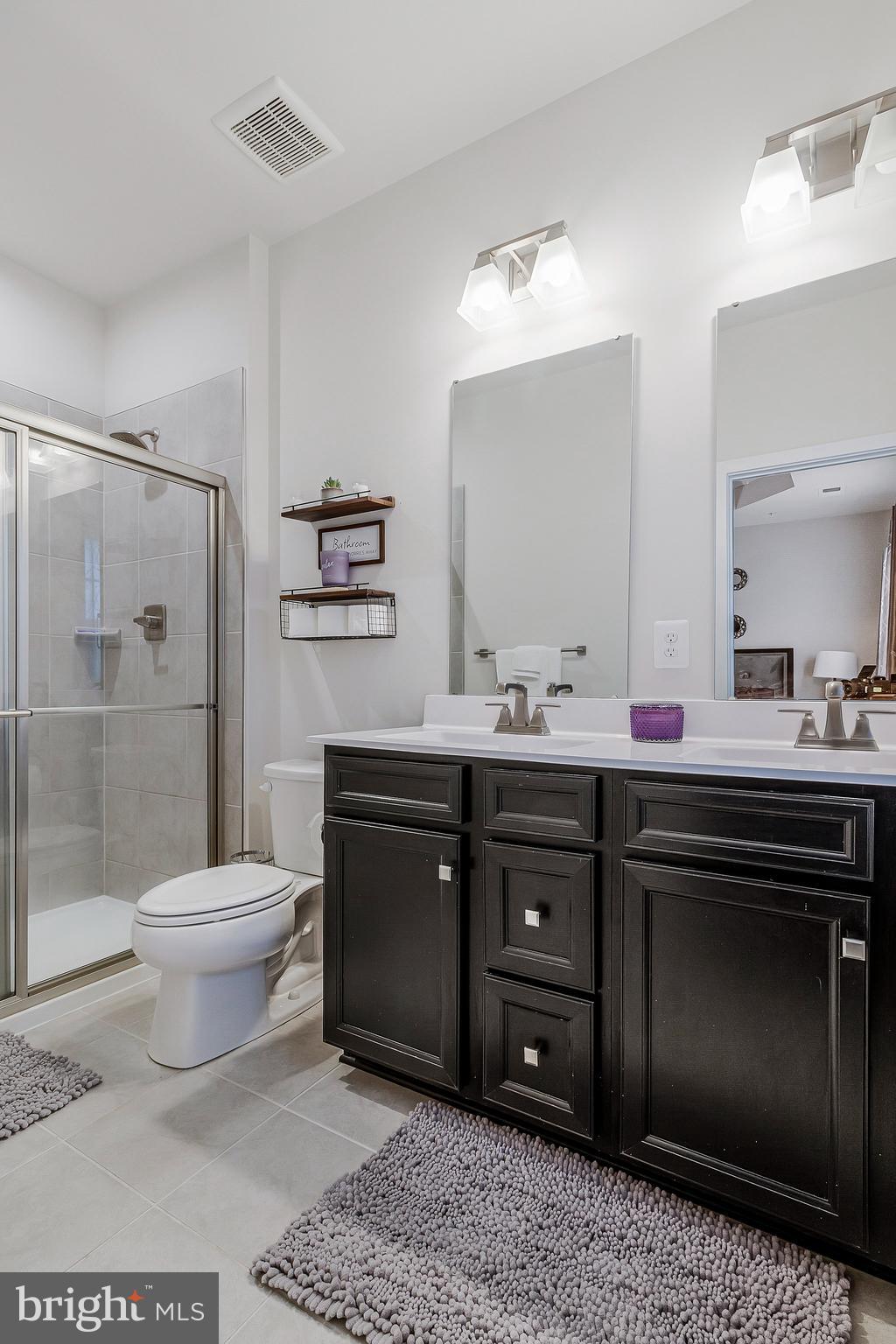 16504 Caribbean Way Accokeek, MD 20607 - Photo 20 of 29 a bathroom with a toilet a sink and a mirror