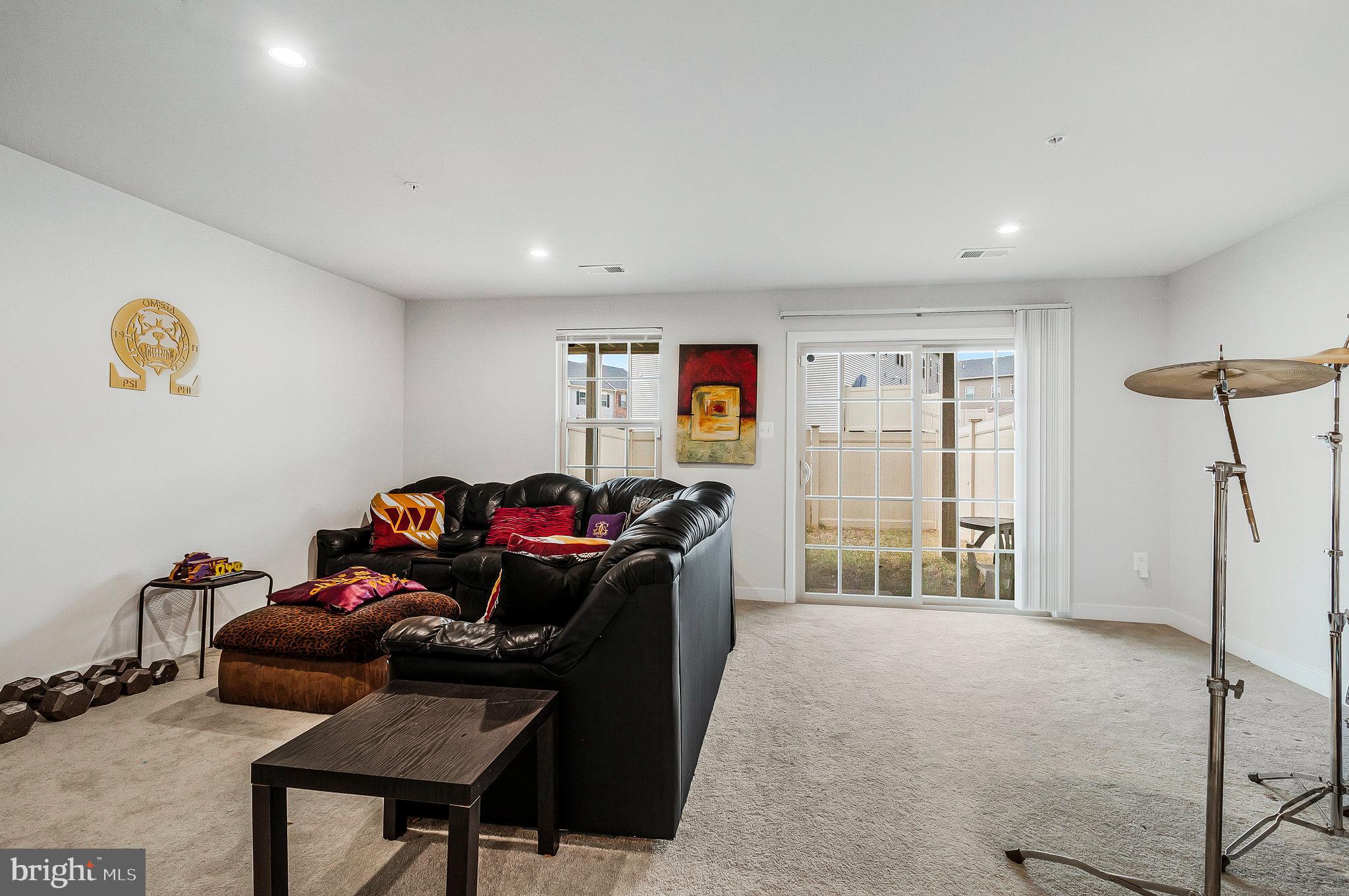 16504 Caribbean Way Accokeek, MD 20607 - Photo 4 of 29 a living room with furniture a window and gym equipment