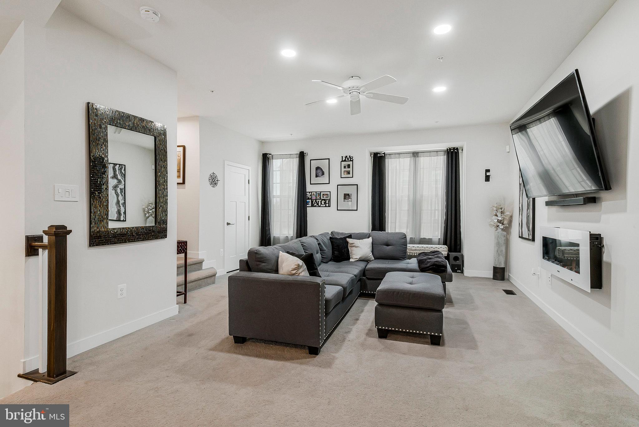 16504 Caribbean Way Accokeek, MD 20607 - Photo 5 of 29 a living room with fireplace furniture and a flat screen tv