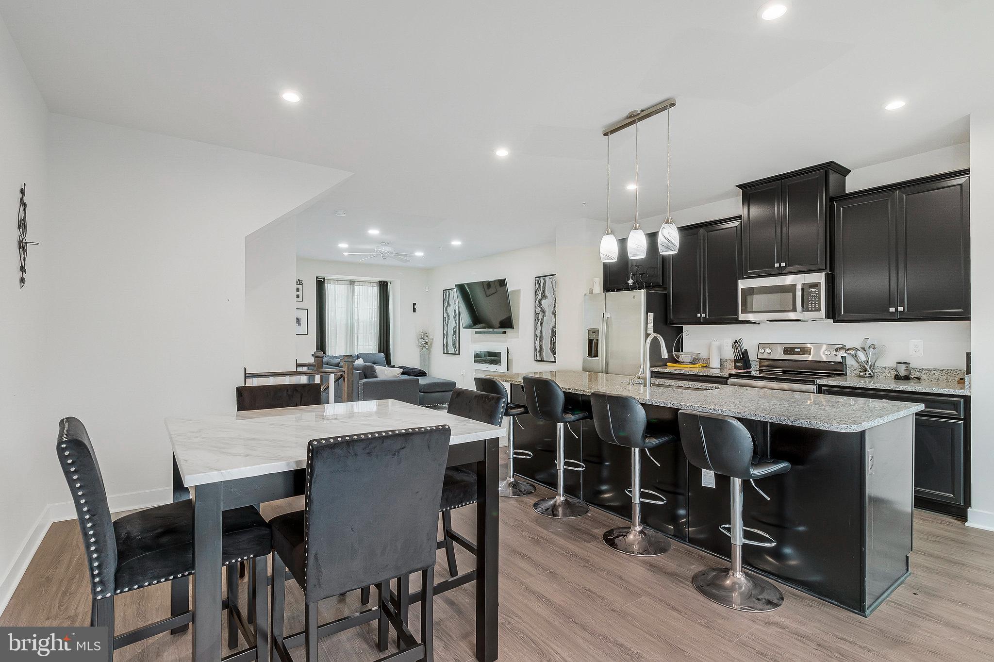 16504 Caribbean Way Accokeek, MD 20607 - Photo 9 of 29 a large kitchen with a table and chairs