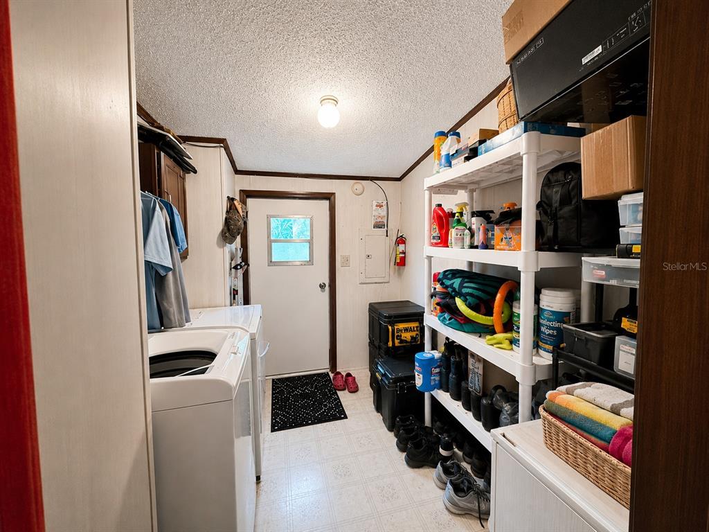 2665 Absher Road St. Cloud, FL 34771 - Photo 27 of 27 a view of walk in closet with clothes shoes and a washer dryer