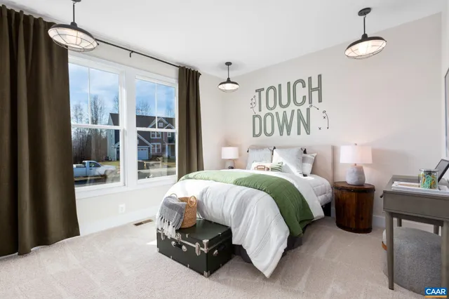 a spacious bedroom with a bed and a large window