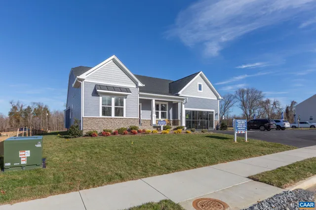 a front view of a house with a yard table and chairs