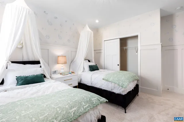 a bedroom with two beds and painted walls