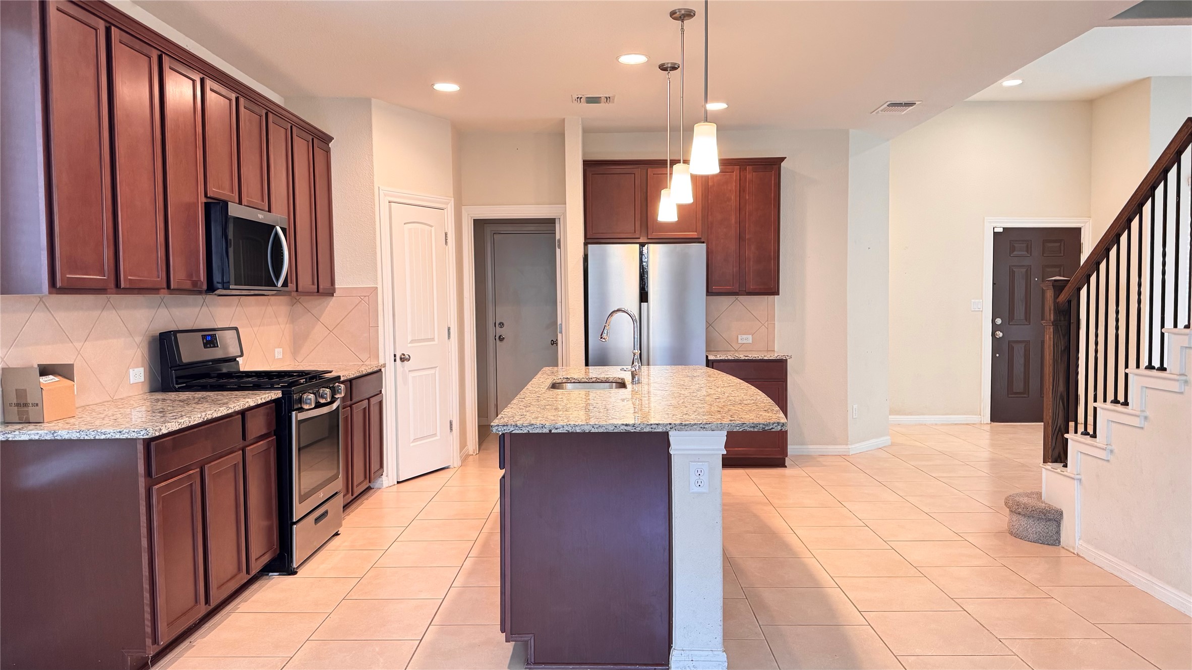 15912 Cessida Street Austin, TX 78728 - Photo 8 of 23 a kitchen with kitchen island granite countertop a sink and refrigerator