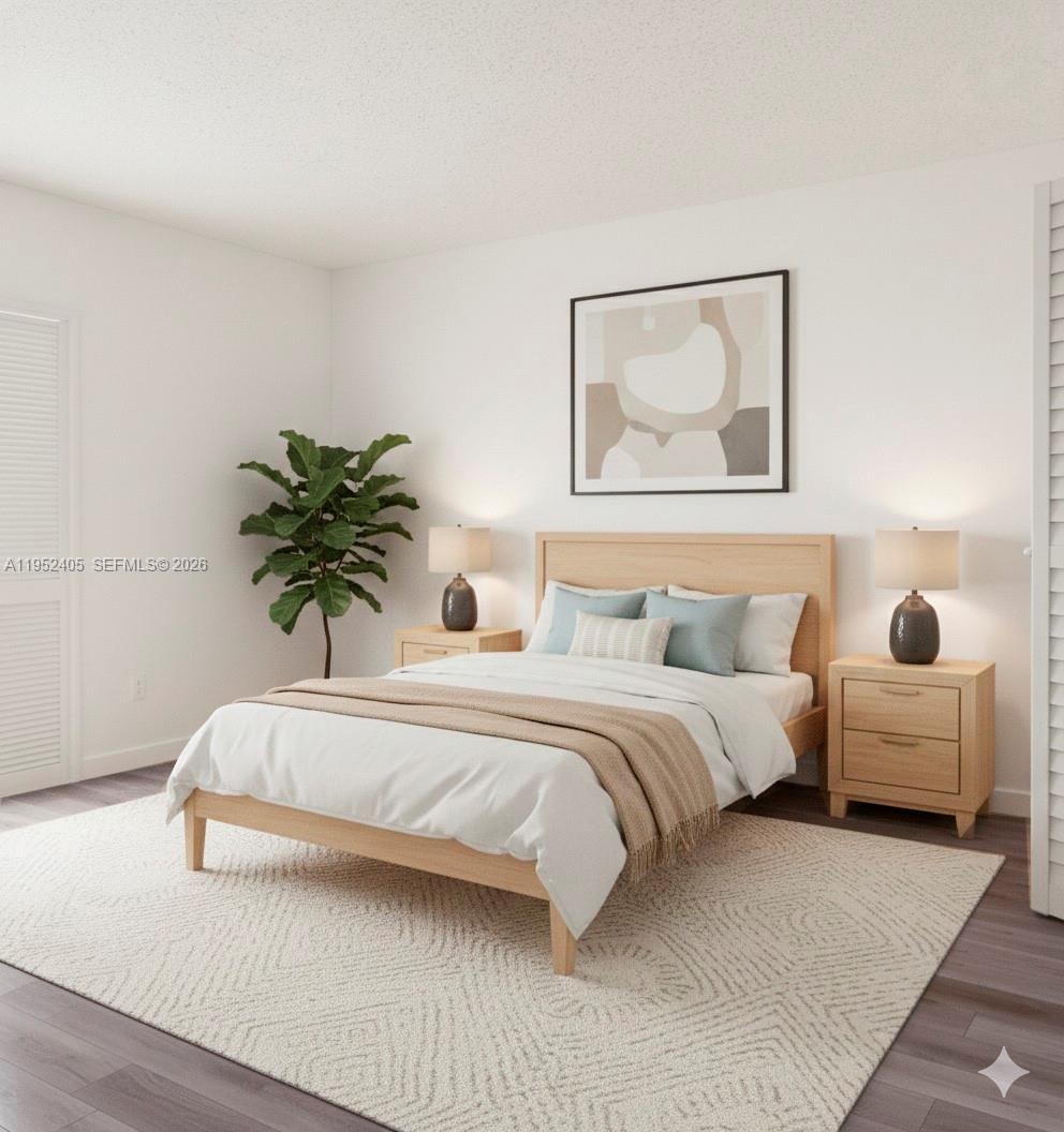 2575 Southwest 27th Avenue, Unit 210 Miami, FL 33133 - Photo 11 of 16 a spacious bedroom with a bed and a couch