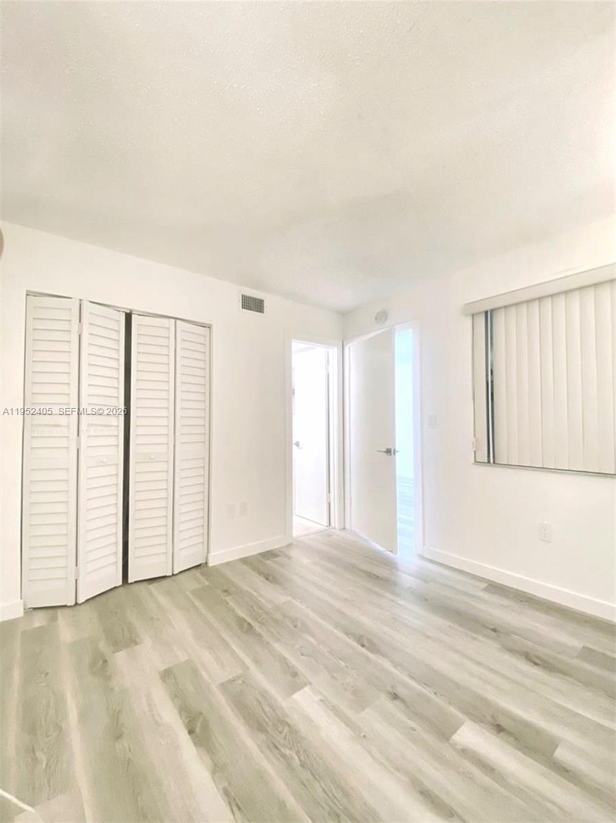 2575 Southwest 27th Avenue, Unit 210 Miami, FL 33133 - Photo 13 of 16 a view of an empty room with a window