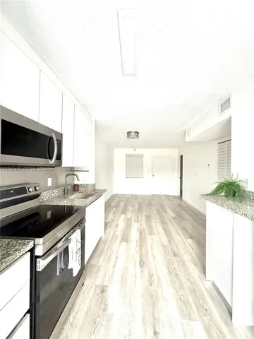 a kitchen with a stove and a sink