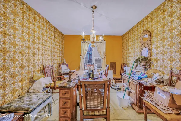 a view of a dining room with furniture and chandelier