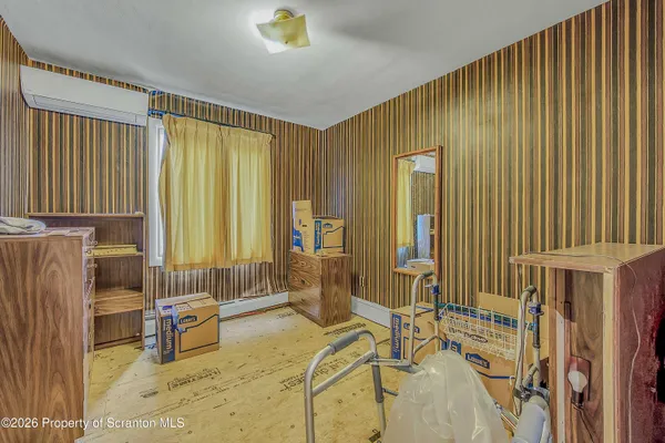 a spacious bedroom with a bed and a large window