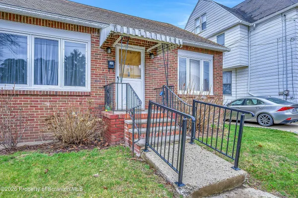 a view of a house with a yard and deck