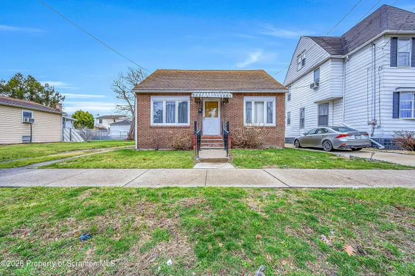 a front view of a house with a garden and yard
