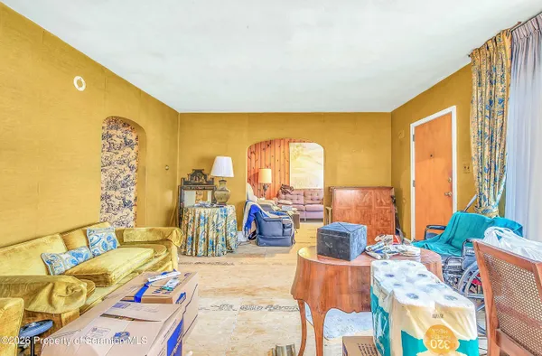 a living room with furniture and floor to ceiling windows