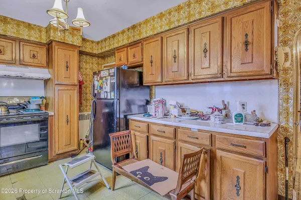 a kitchen with stainless steel appliances granite countertop a cabinets and a stove top oven