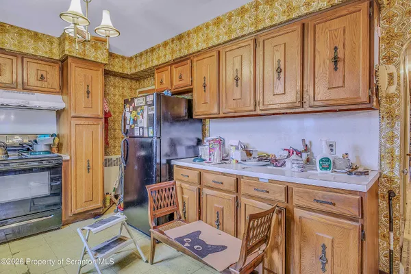 a kitchen with stainless steel appliances granite countertop a cabinets and a stove top oven