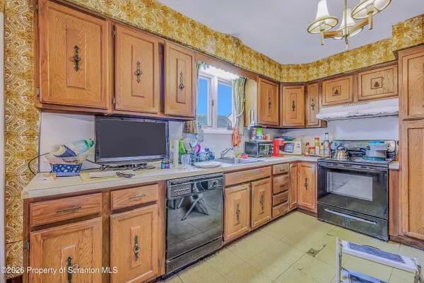a kitchen with stainless steel appliances granite countertop a sink and cabinets