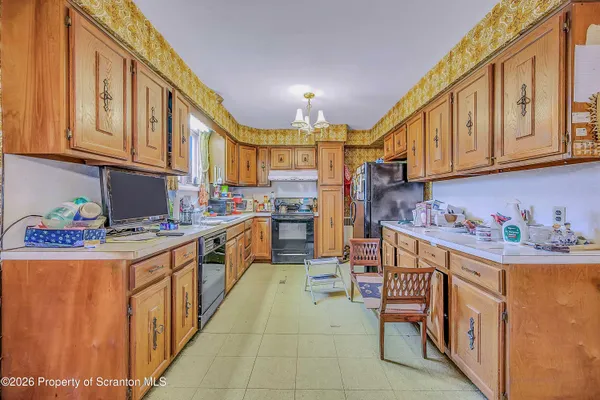 a kitchen with stainless steel appliances granite countertop a stove and a refrigerator
