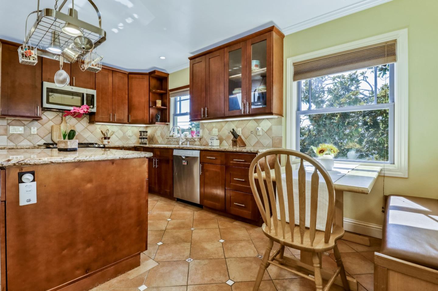 1401 Channing Way Berkeley, CA 94702 - Photo 16 of 43 a kitchen with stainless steel appliances granite countertop a sink dishwasher a stove a dining table and chairs with wooden floor