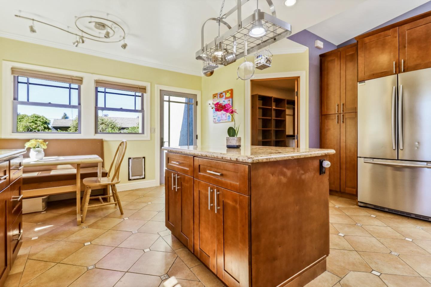 1401 Channing Way Berkeley, CA 94702 - Photo 17 of 43 a kitchen with stainless steel appliances granite countertop a refrigerator a stove and a dining table with granite countertops