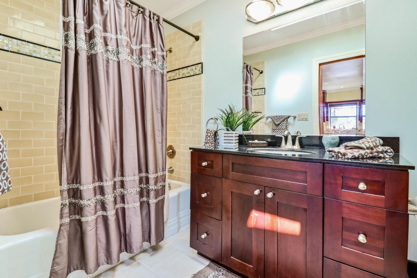 1401 Channing Way Berkeley, CA 94702 - Photo 28 of 43 a bathroom with a double vanity sink a mirror a bathtub and shower