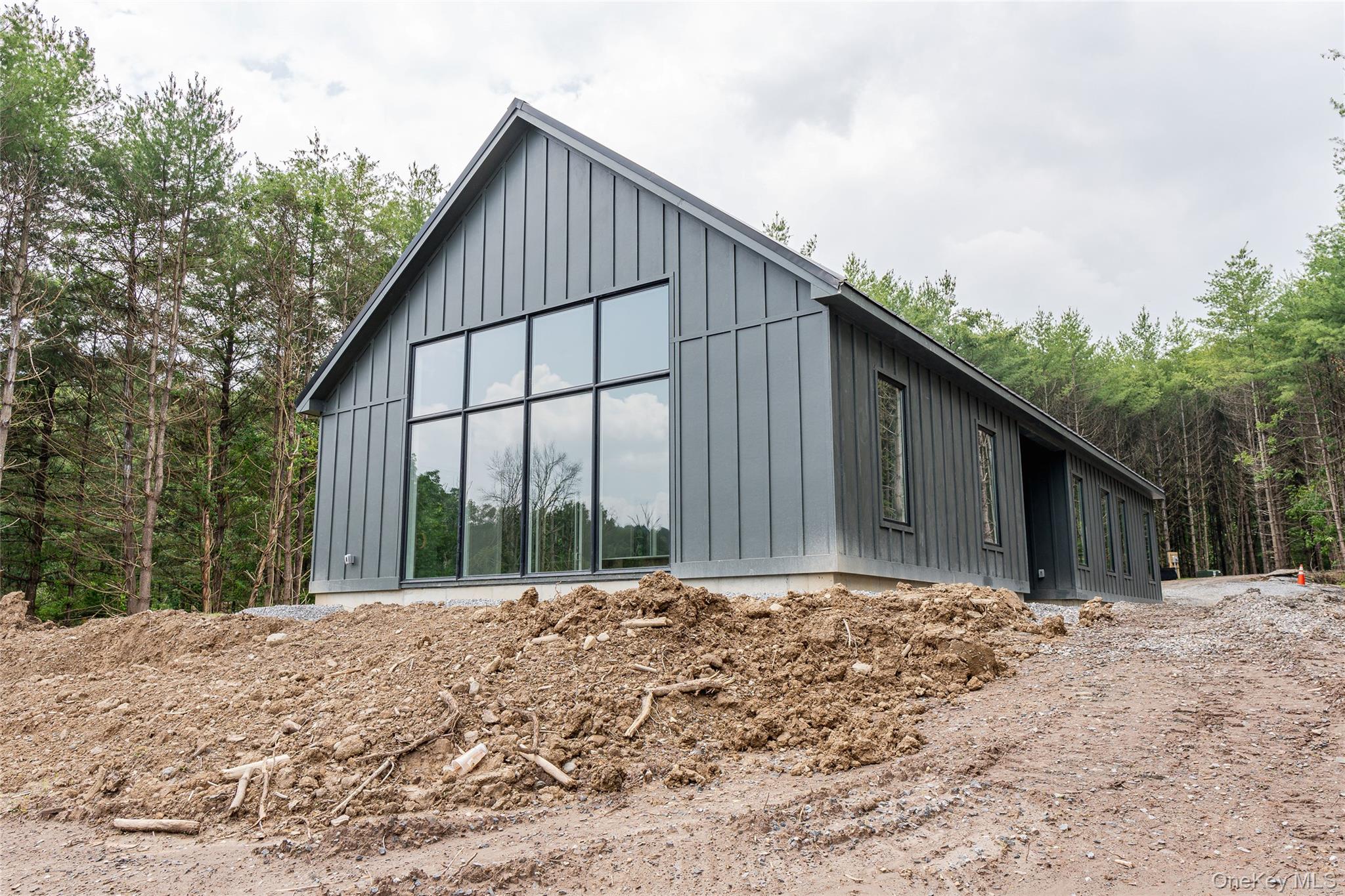 a view of wooden house with large trees