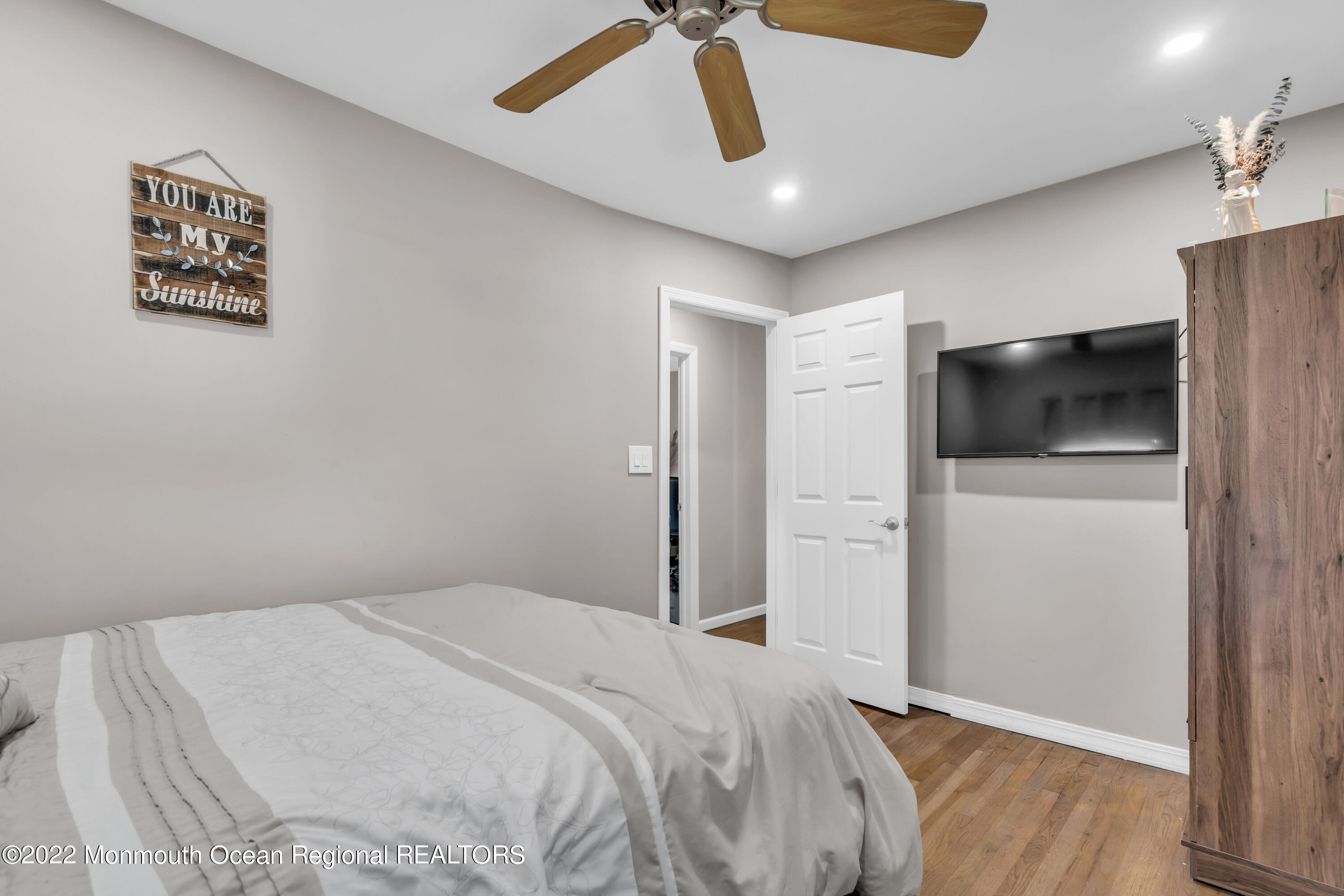 19 Lark Lane Brick, NJ 08724 - Photo 18 of 72 a bedroom with a large bed a flat tv screen and white walls