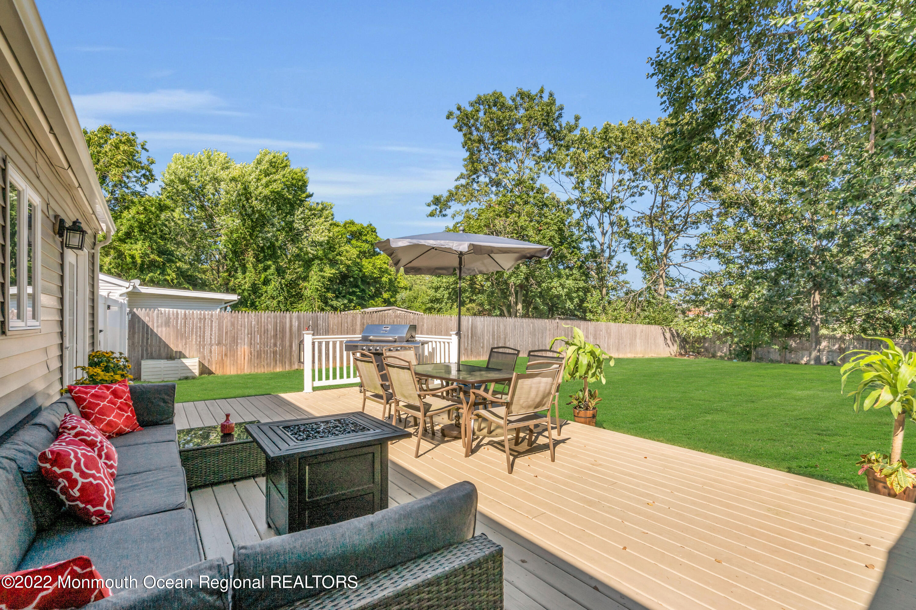 19 Lark Lane Brick, NJ 08724 - Photo 25 of 72 a view of a table and chairs in patio with wooden fence
