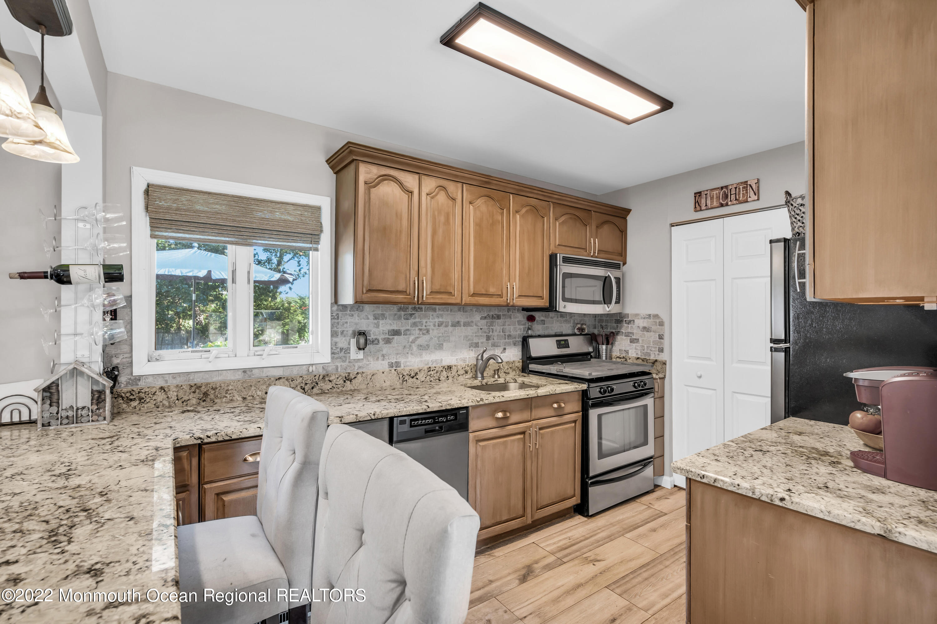 19 Lark Lane Brick, NJ 08724 - Photo 40 of 72 a kitchen with stainless steel appliances granite countertop a sink stove microwave and cabinets