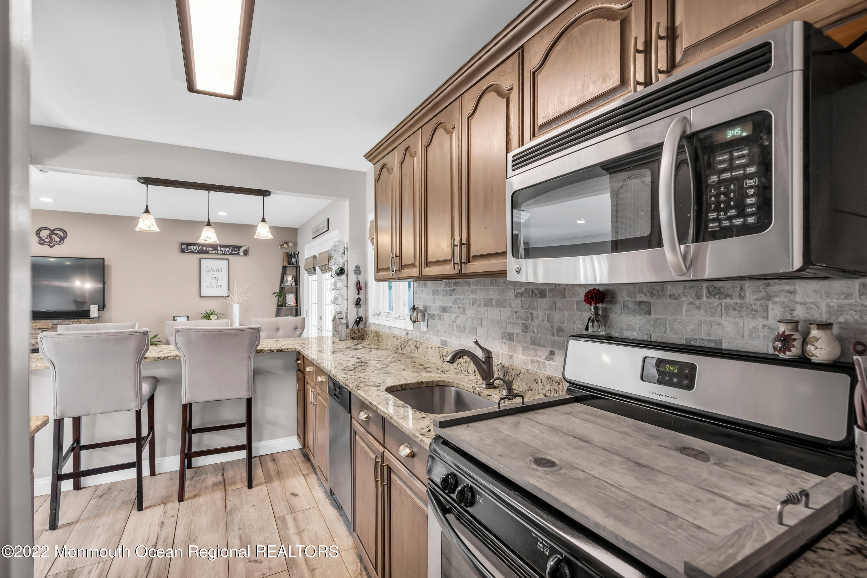 19 Lark Lane Brick, NJ 08724 - Photo 44 of 72 a kitchen with stainless steel appliances granite countertop a stove a sink and a microwave