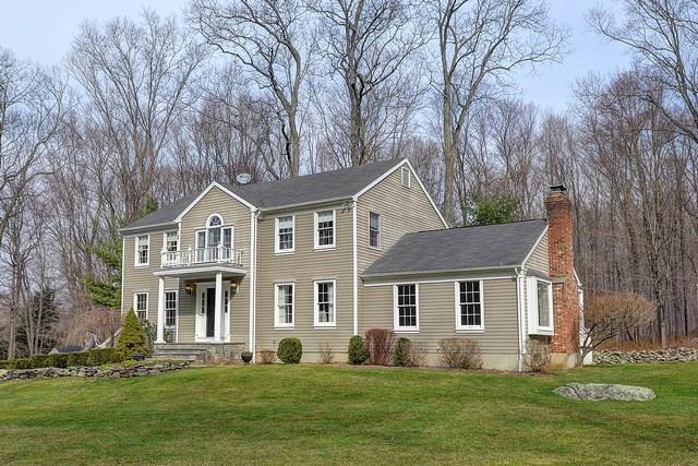 216 Florida Road Ridgefield, CT 06877 - Photo 1 of 1 a front view of a house with a yard and trees