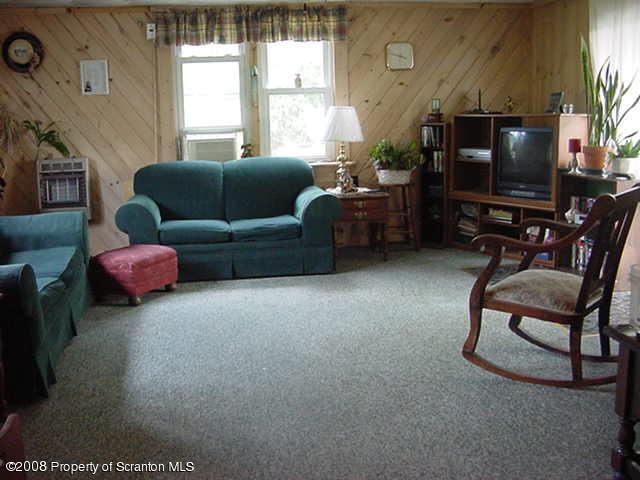 1 Rr Mehoopany, PA 18629 - Photo 4 of 4 a living room with furniture a flat screen tv and a window