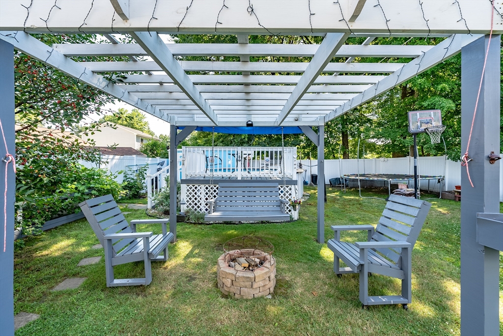 299 Morton Street Springfield, MA 01119 - Photo 8 of 37 a view of a backyard with table and chairs potted plants and a palm tree