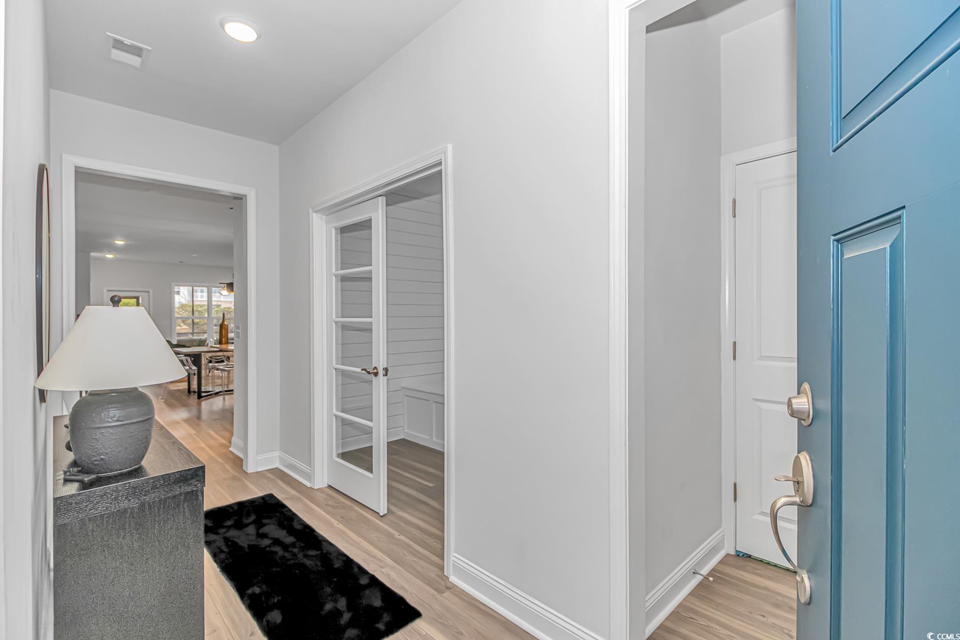 6076 Campanella Street Myrtle Beach, SC 29577 - Photo 11 of 29 Corridor featuring light wood finished floors and baseboards