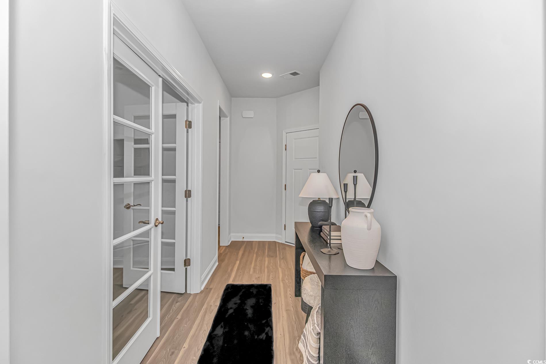 6076 Campanella Street Myrtle Beach, SC 29577 - Photo 12 of 29 Hallway featuring visible vents, light wood-style flooring, baseboards, and recessed lighting