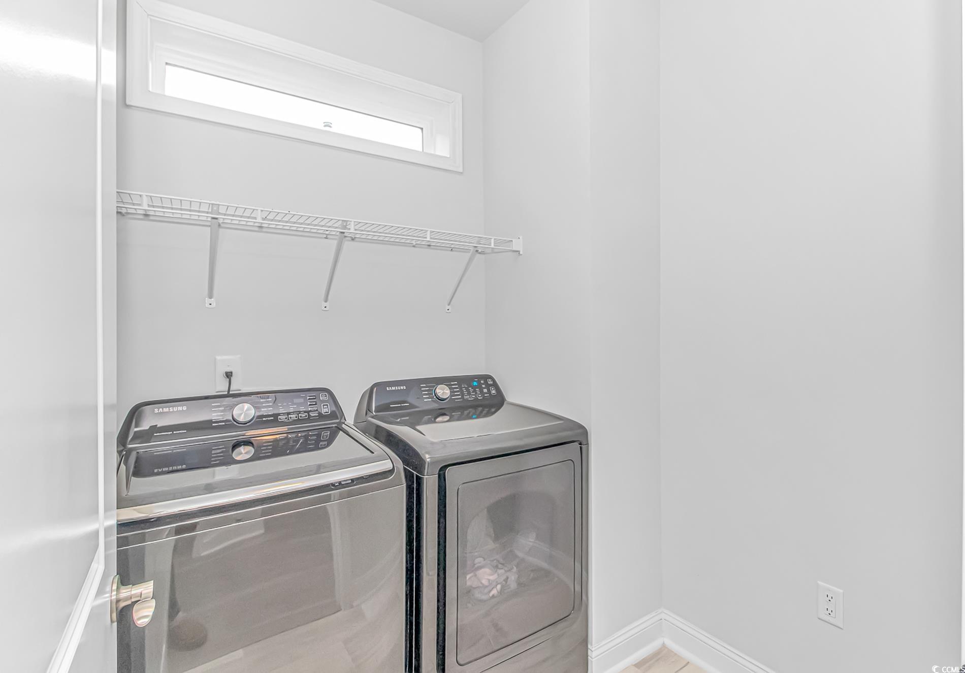 6076 Campanella Street Myrtle Beach, SC 29577 - Photo 15 of 29 Laundry area with washing machine and clothes dryer, baseboards, and laundry area