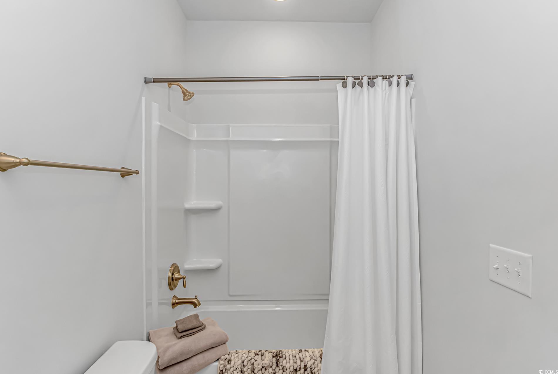 6076 Campanella Street Myrtle Beach, SC 29577 - Photo 16 of 29 Full bathroom featuring toilet and shower / bathtub combination with curtain