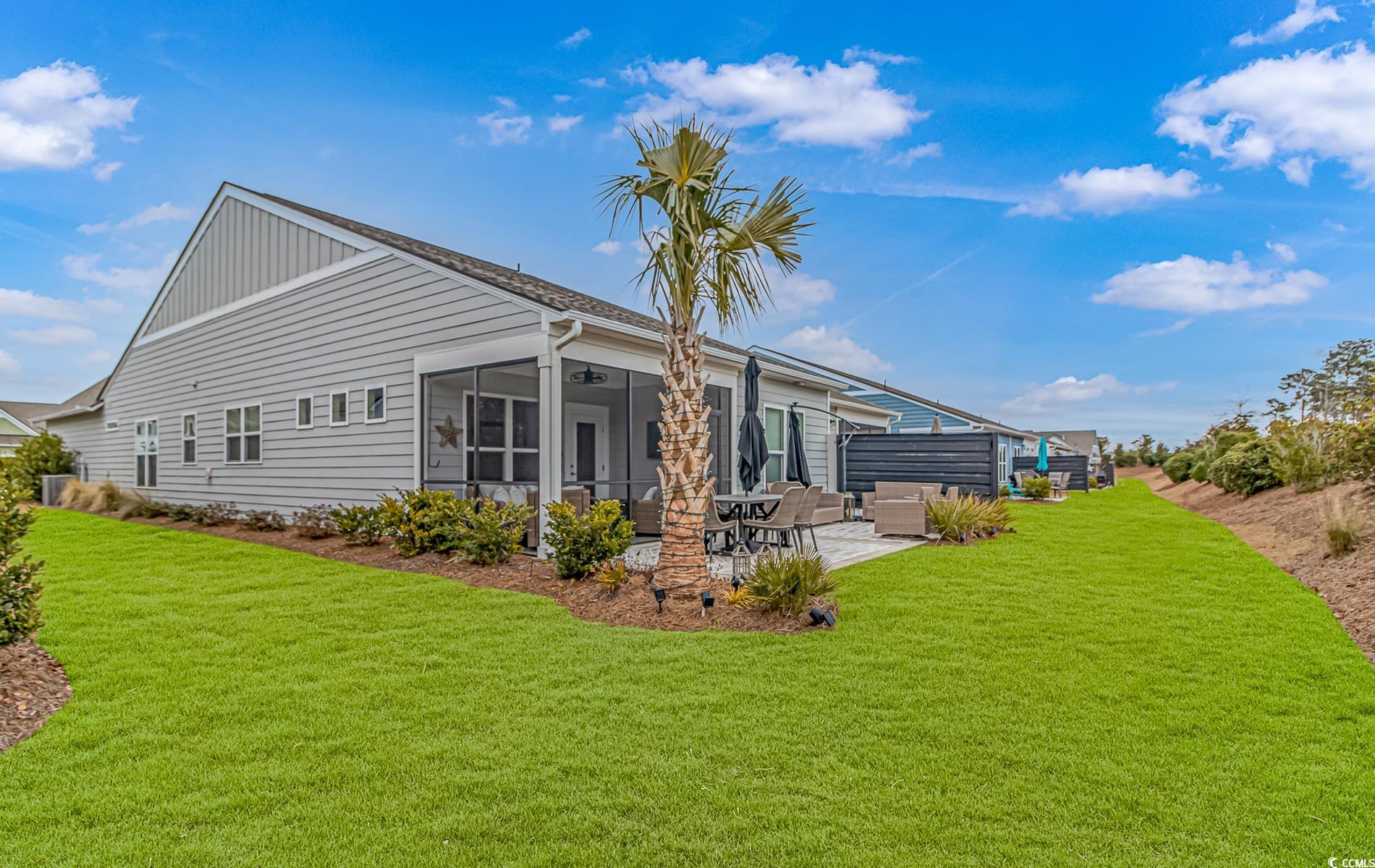 6076 Campanella Street Myrtle Beach, SC 29577 - Photo 27 of 29 Rear view of property featuring a lawn, a patio, a sunroom, and ceiling fan