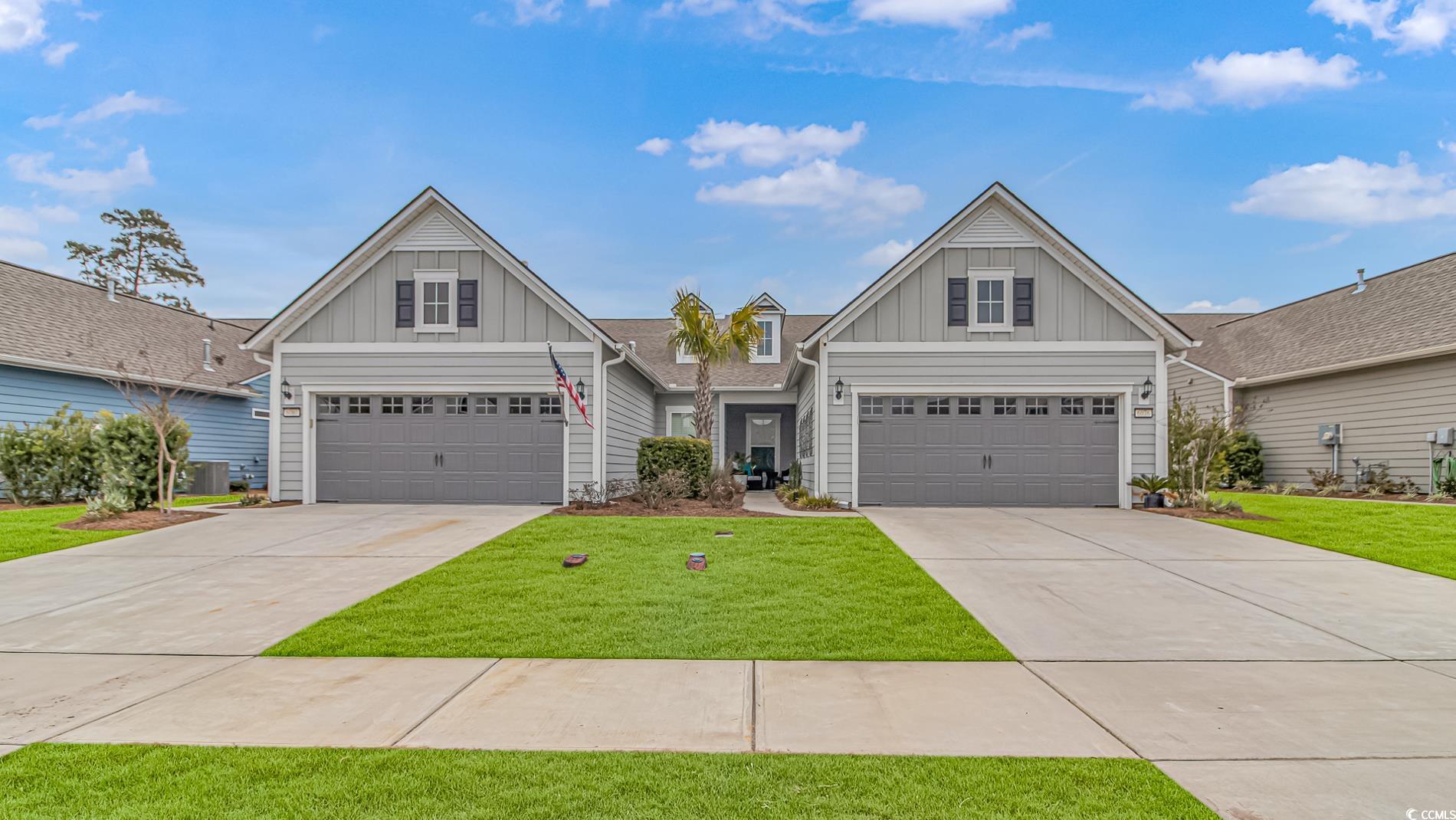 6076 Campanella Street Myrtle Beach, SC 29577 - Photo 28 of 29 Craftsman-style house with a front lawn, board and batten siding, and driveway