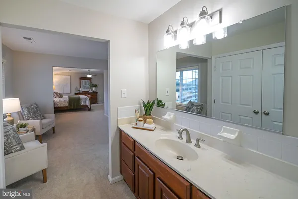 a spacious bedroom with a bed and a chandelier