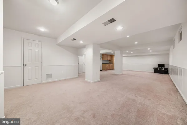 a kitchen with cabinets and a refrigerator