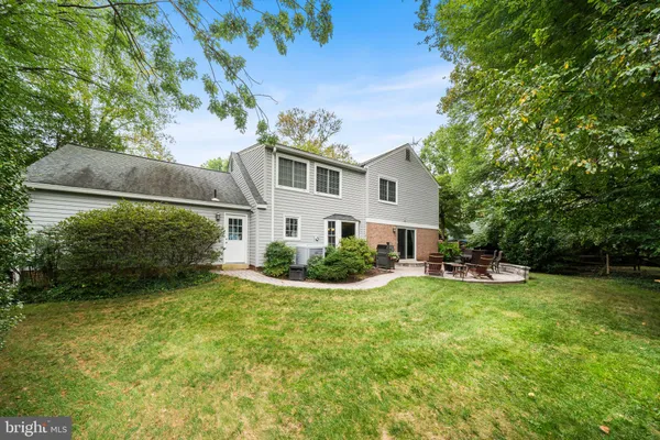 a view of a house with patio and a yard