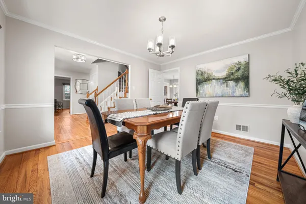 a view of a dining room with furniture wooden floor and a chandelier