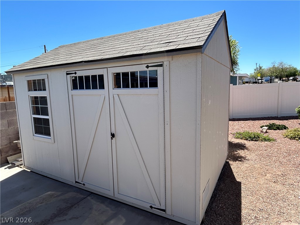 116 West Basic Road Henderson, NV 89015 - Photo 8 of 39 An attractive storage shed with barn-style doors and a shingle roof enhances property utility.