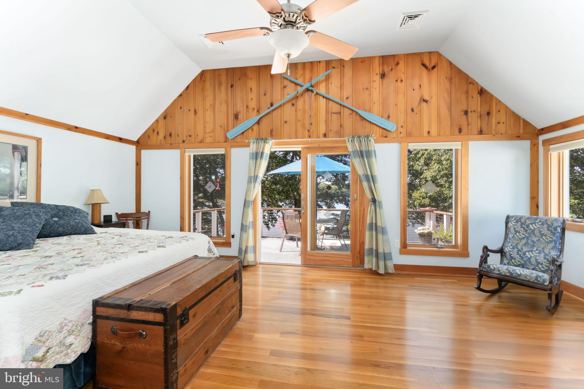 25209 Wymont Park Road Worton, MD 21678 - Photo 24 of 51 a spacious bedroom with a bed a table and large windows