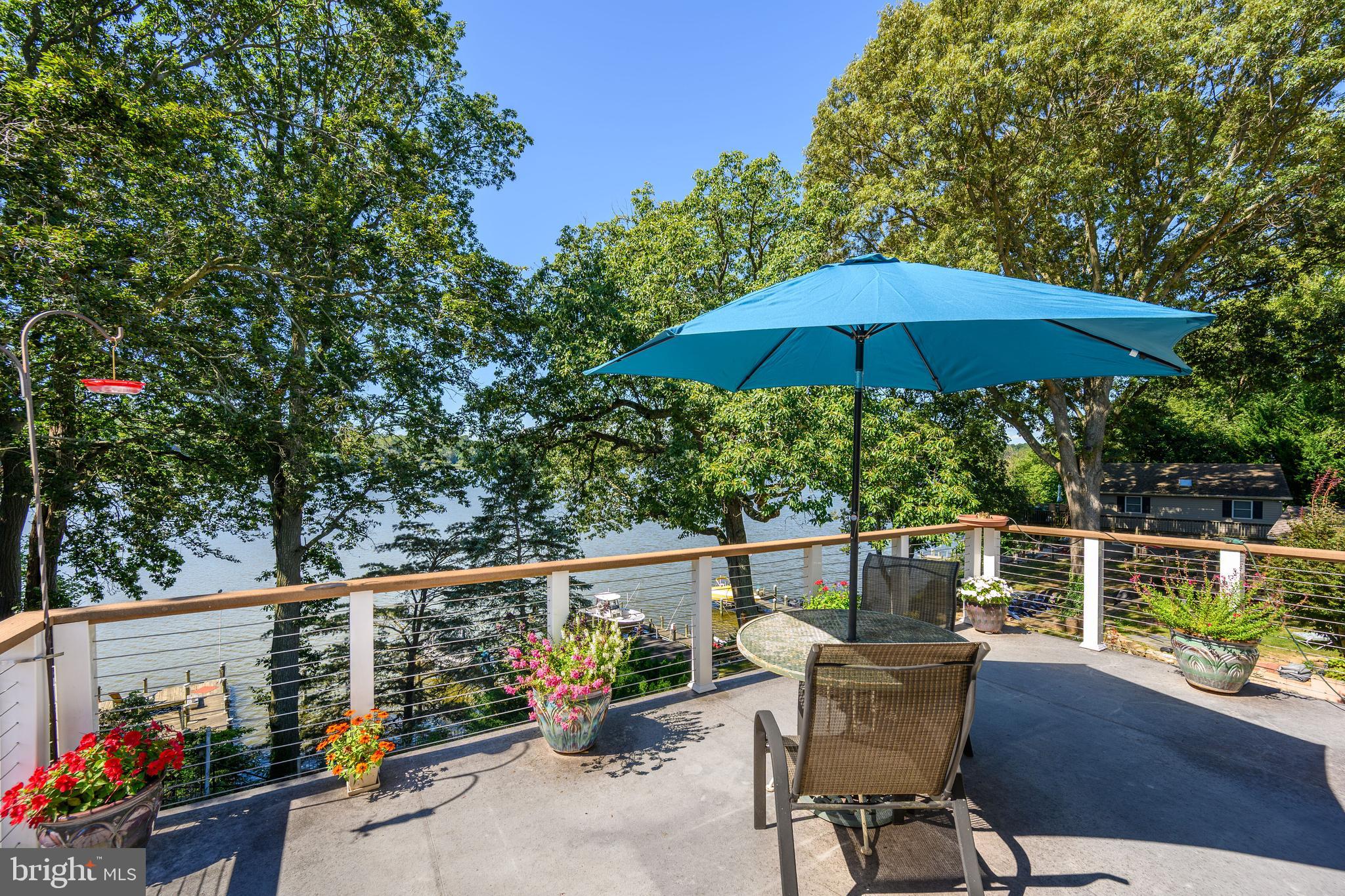 25209 Wymont Park Road Worton, MD 21678 - Photo 27 of 51 a view of a chair and tables on the deck