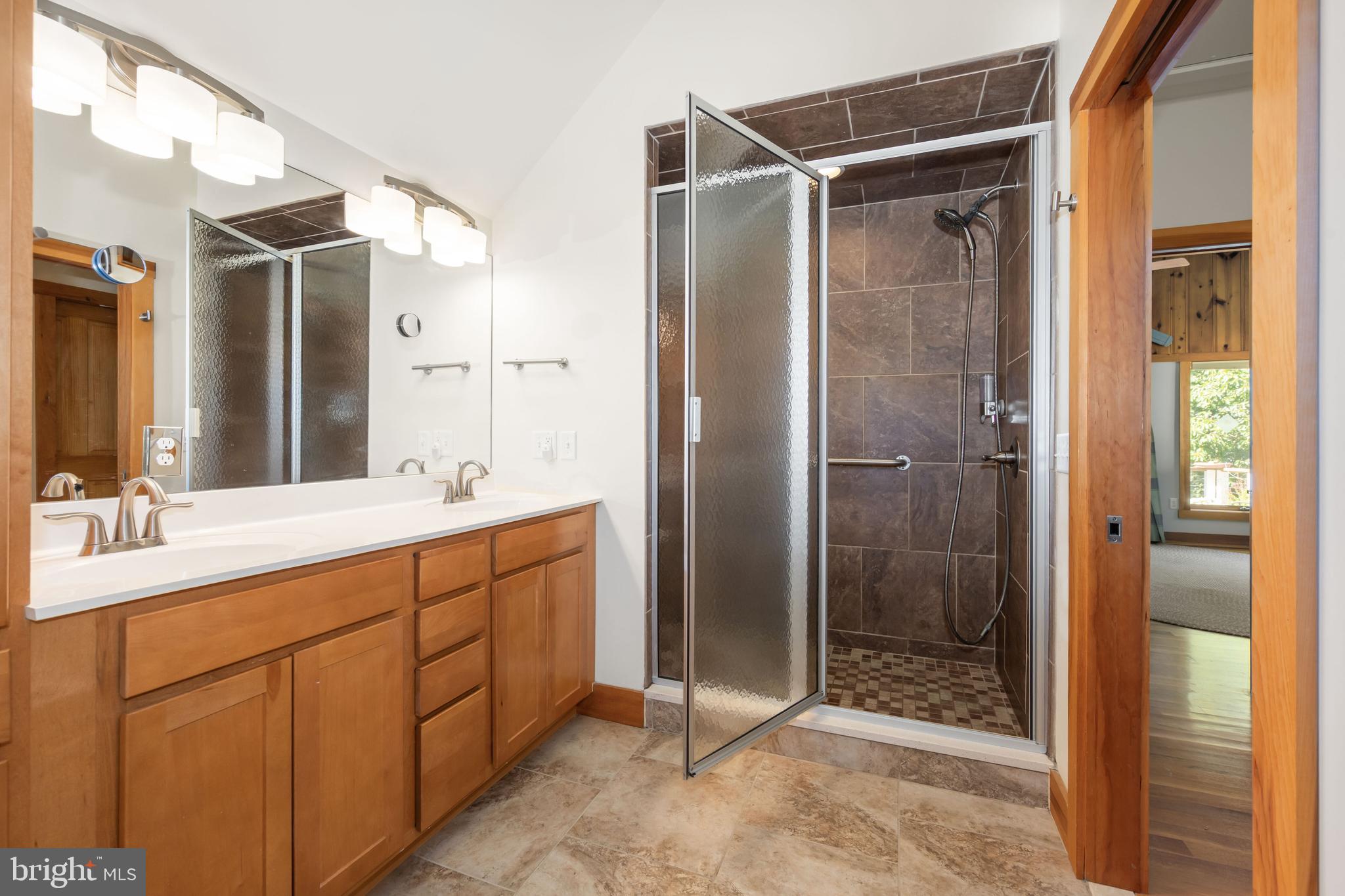 25209 Wymont Park Road Worton, MD 21678 - Photo 29 of 51 a bathroom with a shower sink and mirror