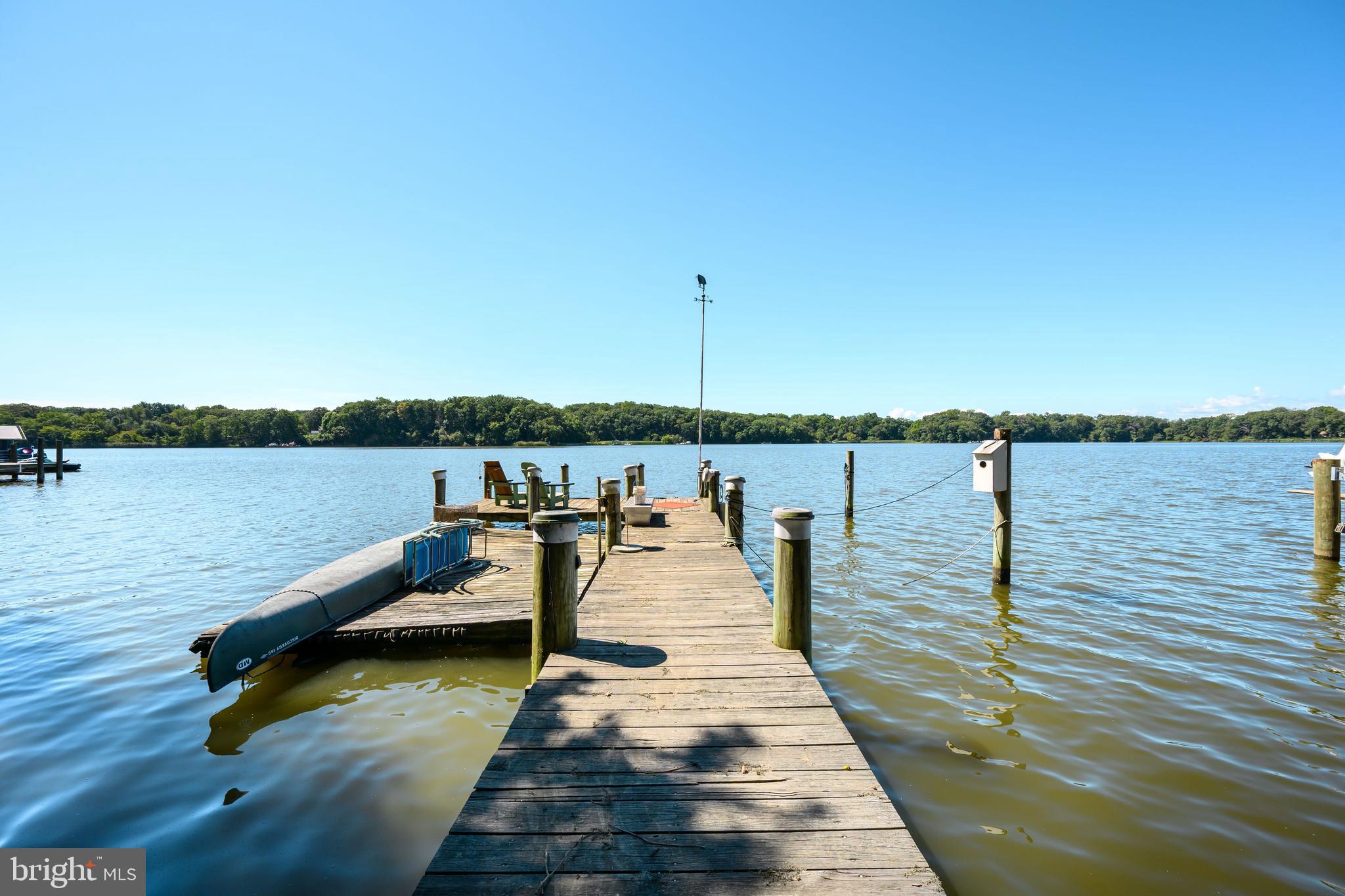 25209 Wymont Park Road Worton, MD 21678 - Photo 47 of 51 a view of a lake with boats and trees in the background