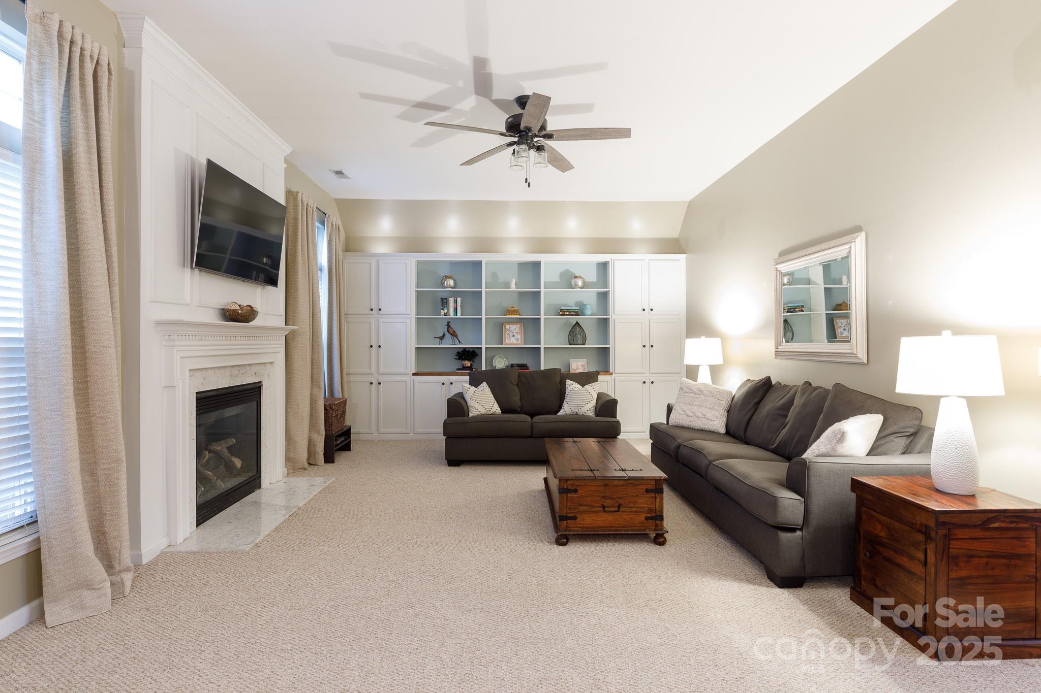 708 Drew Avenue Fort Mill, SC 29708 - Photo 13 of 30 a living room with furniture a fireplace and a large window