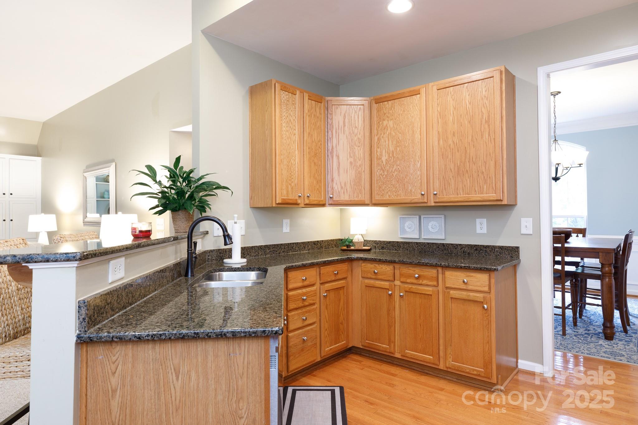 708 Drew Avenue Fort Mill, SC 29708 - Photo 7 of 30 a kitchen with granite countertop a sink a counter top space and cabinets