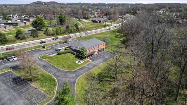 an aerial view of a house with yard